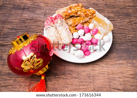 Chinese sweetmeat and Chinese lantern on wooden table