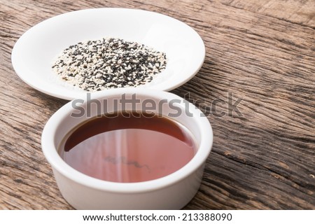 sesame seeds oil and sesame seeds on wooden table top