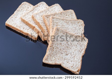 slice whole wheat bread on black background