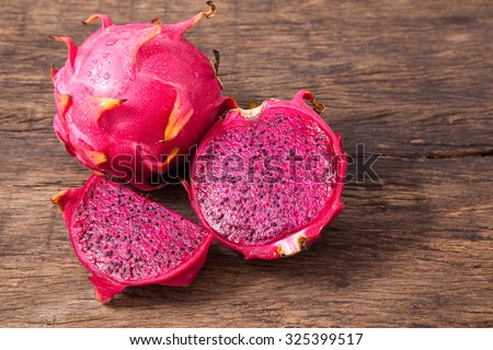 Fresh red dragon fruit with cut dragon fruit and slice on wooden background