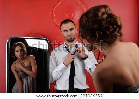 man and woman(girl/lady). man dressed in black suit. woman in dress. They love each other. love story. pre wedding shooting. Models in black, white and red. romance. relation. mirror . luxury