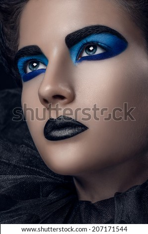 Girl black blue makeup grid laid up hair