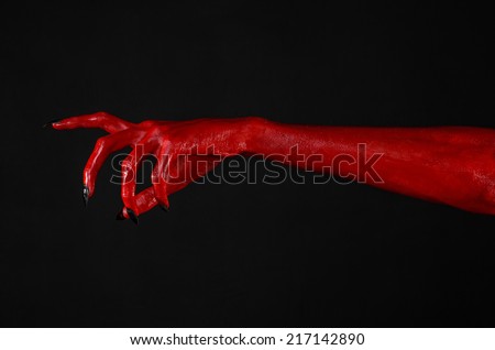 Red Devil\'s hands, red hands of Satan, Halloween theme, black background, isolated