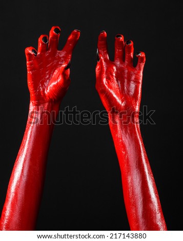 Red Devil\'s hands, red hands of Satan, Halloween theme, black background, isolated