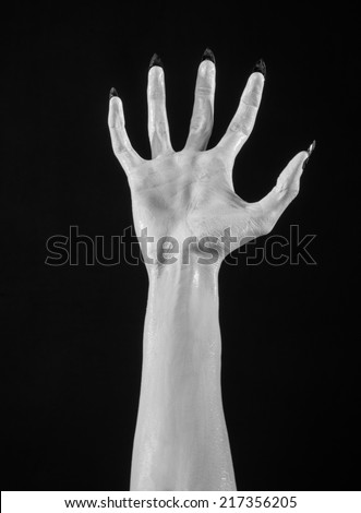 white hands of death with black nails, white death, the devil's hands, the hands of a demon, white skin, halloween theme, black background, isolated