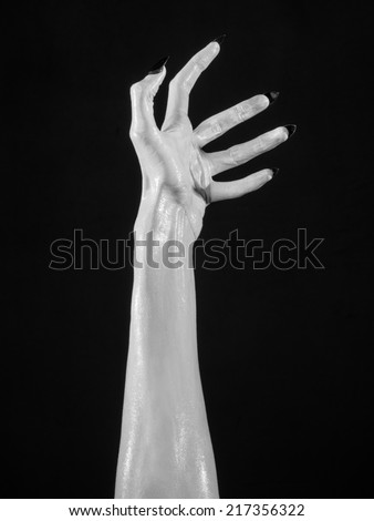 white hands of death with black nails, white death, the devil\'s hands, the hands of a demon, white skin, halloween theme, black background, isolated