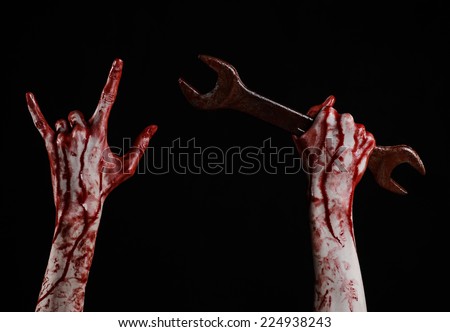 bloody hand holding a big wrench, bloody wrench, big key, bloody theme, halloween theme, crazy mechanic, murderer, psycho, violence, zombies, black background, isolated, revolution