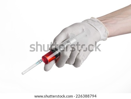 Doctor\'s hand holding a syringe, white-gloved hand, a large syringe, medical issue, the doctor makes an injection, white background, isolated, white gloves doctor, ebola test, red medication