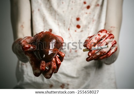 Social advertising and tobacco control: bloody hand holding a cigarette smoker and bloody human heart