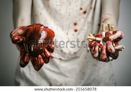 Social advertising and tobacco control: bloody hand holding a cigarette smoker and bloody human heart
