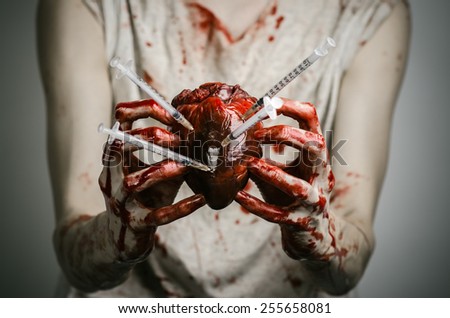 Social advertising and the fight against drug addiction: bloody hands addict holding syringe and bloody human heart