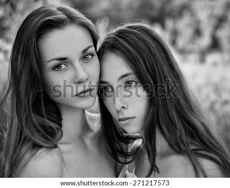 Dramatic portrait of a girl portrait of two beautiful girls in the woods