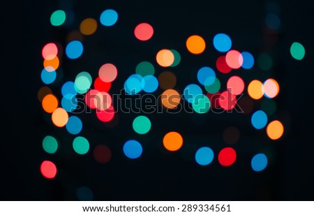 Abstract blurred background and theme: colorful bokeh blurred lights on a dark background