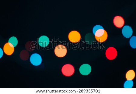 Abstract blurred background and theme: colorful bokeh blurred lights on a dark background