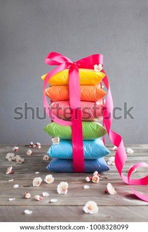 Bright colours in shape of a gift for Indian holi festival. Colorful gulal (powder colors) for Happy Holi.