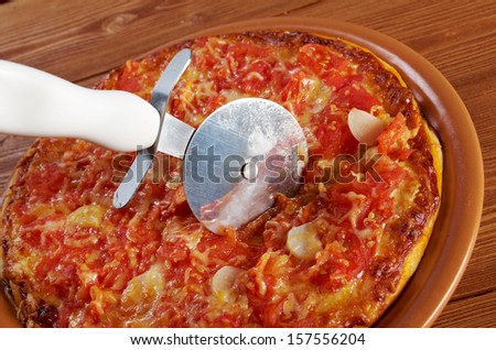 Pizza Marinara .taking slice of pizza,melted cheese dripping  closeup . farmhouse kitchen
