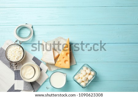 Flat lay composition with different dairy products on wooden background