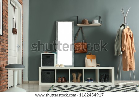 Stylish hallway interior with mirror and hanger stand