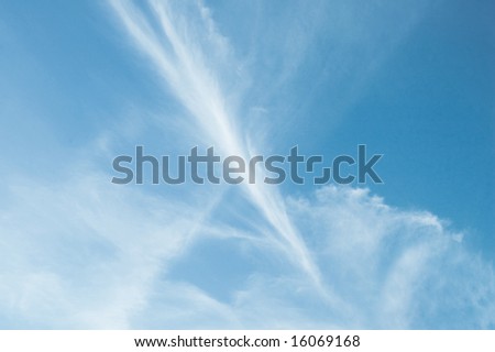 Thin wispy cloud plume on perfect blue sky.