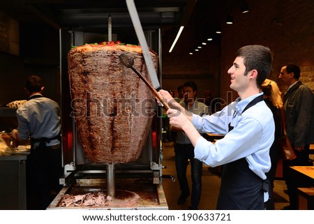 Istanbul, Turkey 03 May 2014: A chef cutting traditional Turkish food Doner Kebab in the restaurant