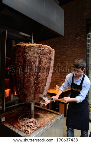 Istanbul, Turkey 03 May 2014: A chef cutting traditional Turkish food Doner Kebab in the restaurant.