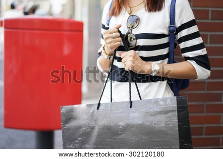 Image of shopaholic arm with  shopping bags