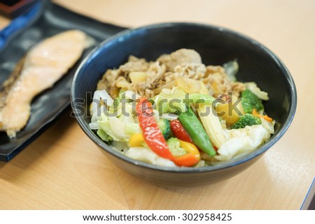 pork rice bowl, bowl of rice with food on top