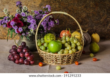 Still Life with Fruit baskets are arranged with a beautiful vase of flowers.