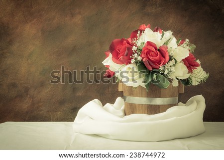 red roses and white roses artificial on a white background with space for text input.