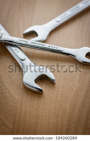 Wrenches on a wooden work bench.