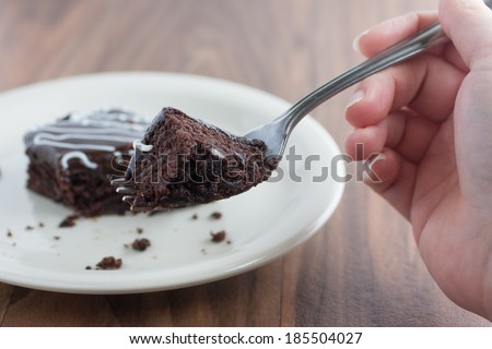 Chocolate Fudge Brownie on a fork from the perspective of a person eating it.