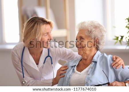Doctor visiting senior woman at home