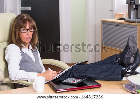 Business woman with legs on the desk