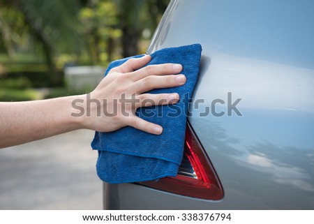 Cleaning the  car with microfiber cloth and wax coating