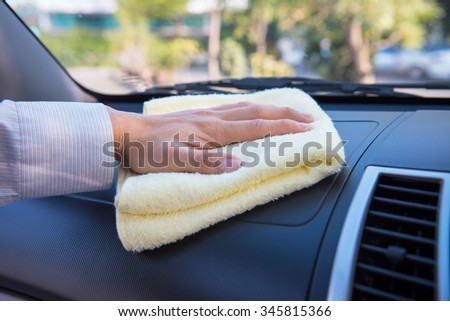 Hand cleaning car with microfiber cloth, wipe interior