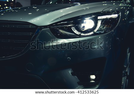 Headlight of a modern luxury car, auto detail,car care concept