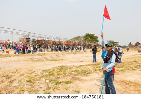 PHITSANULOK, THAILAND - MARCH 29, 2014.  Referee hold red flag and give a signal in \