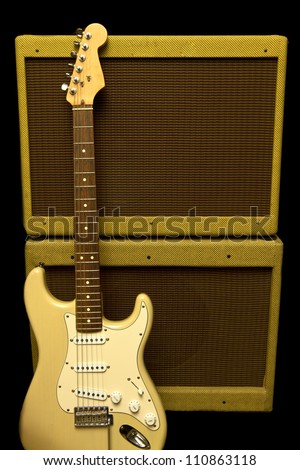 Guitar and amp isolated on a black background.