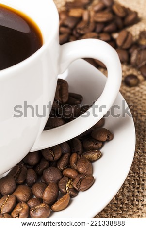 Closeup two handle mug with coffee beans