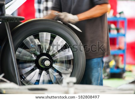 Inside a garage - changing wheels-tire during spinning wheel
