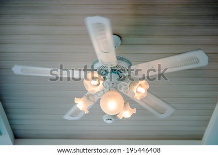 Vintage ceiling fan and lamp fixture in hotel