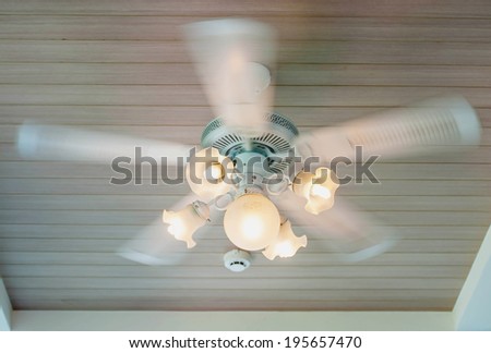 Vintage ceiling fan and lamp fixture in hotel