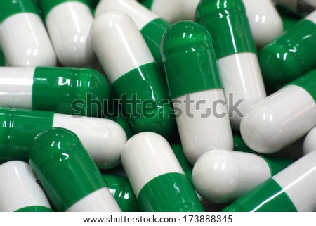 green and white capsules close up