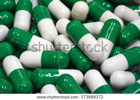 green and white capsules close up