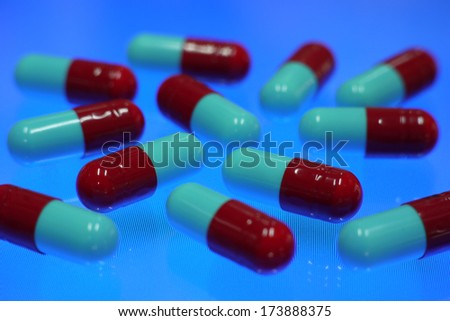 red and blue capsule on blue backround
