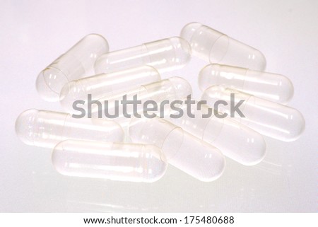 Empty capsules on white background
