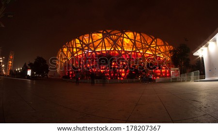 BEIJING, CHINA - Oct 13, 2014 : Unidentified people visit Beijing National Stadium at evening in Beijing, China, the building also known as the Bird\'s Nest stadium