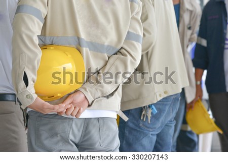 Engineer hold hardhat with team work