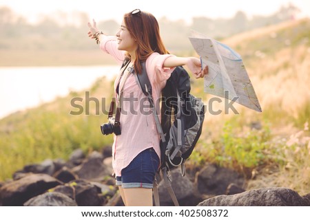 Freedom traveler woman standing with raised arms and enjoying a beautiful nature