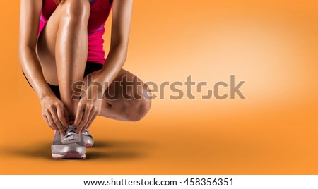 Running shoes - woman tying shoe laces. Closeup of female sport fitness runner getting ready for jogging